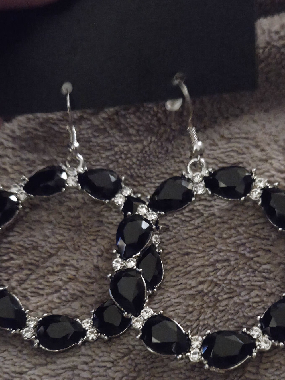 Silvertone Circular Hoop Earrings With Black Teardrop Stones